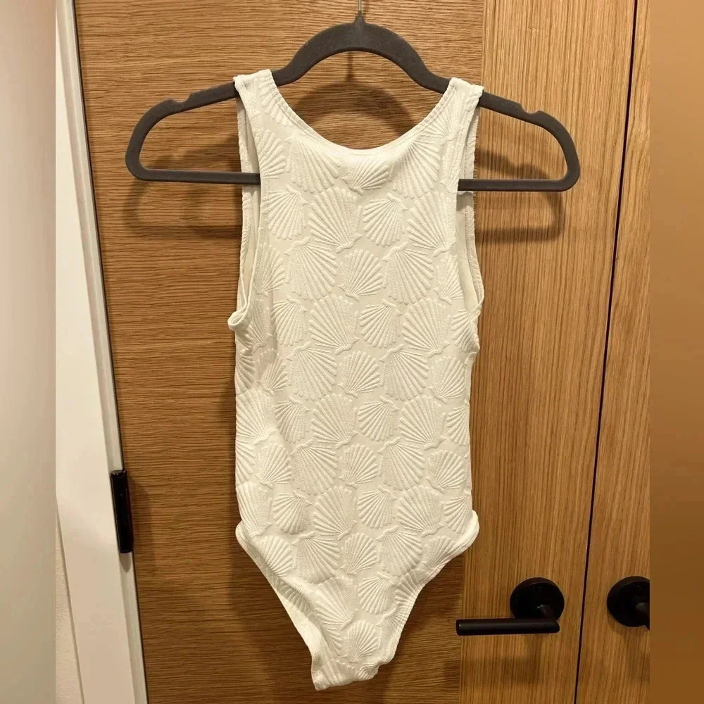 Topshop NWT One piece swimsuit with cutouts. Shell design. Cream white color.